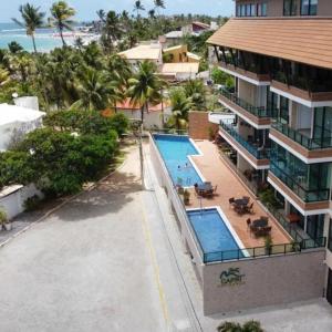 an aerial view of a resort with a swimming pool at Capri Residence Luxo 02 quartos by Premium Reservas in Porto De Galinhas