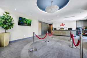 a lobby with red ribbon barriers in front of a pharmacy at Charming Home With Private Pool Near Disney With Water Park & Resort Access At Encore Resort - 7489Mr in Kissimmee