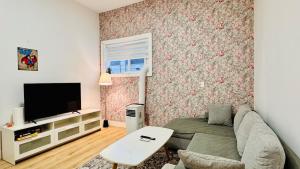 a living room with a couch and a tv at Spacious Home Perfect for Two Families or Groups in Langley