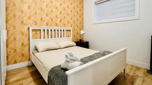 a bedroom with a white bed and a window at Spacious Home Perfect for Two Families or Groups in Langley