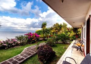 a porch of a house with a view of the ocean at Hotel Sak'cari El Amanecer in San Pedro La Laguna