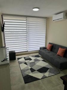 a living room with a couch and a rug at Departamento en Linares in Linares