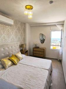 a bedroom with a large bed and a window at Benalmadena Minerva - Ocean view 1 Bedroom apartm in Benalmádena +11 photos