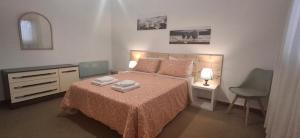 a bedroom with a bed with two towels on it at Moradia santa comba in Santa Comba Dão