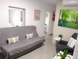 a living room with a couch and a painting on the wall at Casa Fortu La Palma in Los Llanos de Aridane