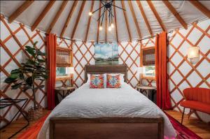 a bedroom with a bed in a yurt at Rustic Luxe Yurt- Unit #1 in Woodway