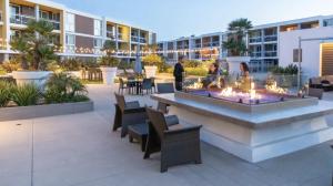 a courtyard with a fire pit in the middle of a building at Charming Bliss By the Ocean LUXE 2bd 2ba MDR in Los Angeles