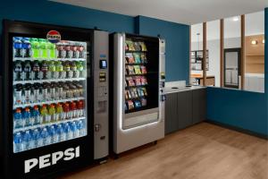 a soda machine in a store with soda sodas at StudioRes by Marriott Fort Myers Airport in Miromar Lakes