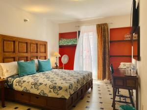 a bedroom with a bed and a desk and a window at Hotel Doña Chela En Calvillo in Calvillo +75 photos
