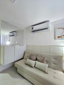 a living room with a couch in a room at Edifício Porto City, estrutura completa no centro de Porto By HM in Porto De Galinhas +265 photos