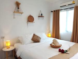 a bedroom with a white bed with flowers and two lamps at Feel Home in Hinkong