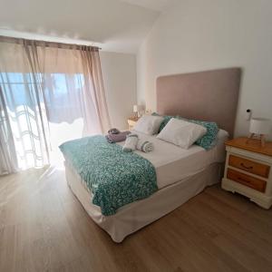 a bedroom with a bed and a large window at Dúplex Frente al Mar - Salobreña in Salobreña