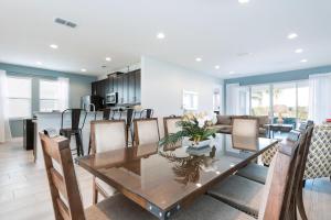 キシミーにあるModern Home Near Disney With Private Pool, Media Room And Waterpark & Resort Access At Encore Resorts Reunion - 7576Mrのテーブルと椅子のあるダイニングルームとリビングルーム