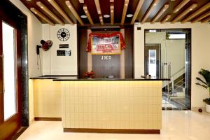 a lobby with a counter in a building at JMD Royal Residency I Luxury 3-Star Hotel in Varanasi
