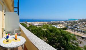 a balcony with a table and a view of a city at Hotel Alba Serena in Misano Adriatico