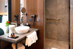 a bathroom with a sink and a shower at City Park Hôtel in Casablanca