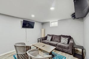 a living room with a couch and a table at Beach Bungalow Getaway in Michigan City