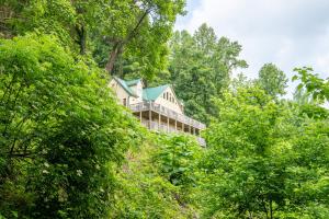 a house on a hill surrounded by trees at Endless Horizons By Avada Properties in Little Cove