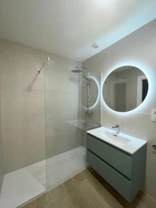 a bathroom with a sink and a glass shower at Dúplex Frente al Mar - Salobreña in Salobreña +12 photos