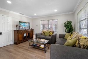 a living room with a couch and a table at Stunning Tampa Stay - Prime Location & Comfort in Tampa