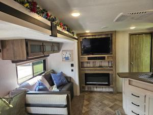 a living room with a couch and a tv in a caravan at Tranquil Stay Close to Hotspots in Medway