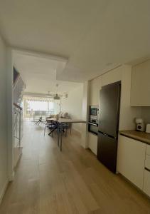a kitchen and living room with a table and a refrigerator at Dúplex Frente al Mar - Salobreña in Salobreña