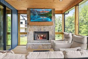 a living room with a fireplace and a tv at NEW Spacious Clarkson Getaway w Games & Yard in Clarkson