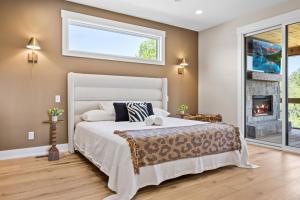 a bedroom with a white bed and a fireplace at NEW Spacious Clarkson Getaway w Games & Yard in Clarkson