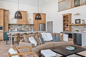 a living room with a couch and a kitchen at NEW Spacious Clarkson Getaway w Games & Yard in Clarkson +56 photos