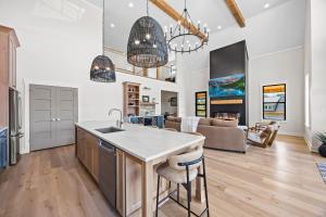 a kitchen and living room with a sink and a counter at NEW Spacious Clarkson Getaway w Games & Yard in Clarkson