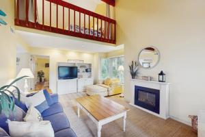 a living room with a blue couch and a fireplace at Windward Village 109 in Hilton Head Island