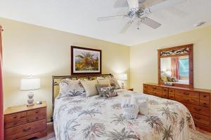 a bedroom with a bed and a ceiling fan at Windward Village 109 in Hilton Head Island