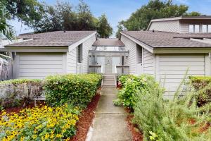 a house with two garages in a garden at Windward Village 109 in Hilton Head Island