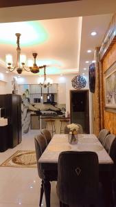 a dining room with a table and a kitchen at SeaView 2BR with parking, Walk to Dolmen Mall & Park in Karachi