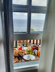 a table with food and wine glasses in a window at Sabela Mar in Barlovento
