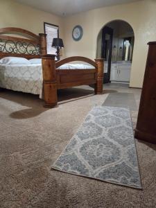 a bedroom with two beds and a rug on the floor at Su casa in Yuma