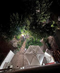 an overhead view of an umbrella on a brick sidewalk at Casa Vacanze "Il Giardino" in Furnari