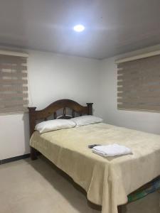 a bedroom with a bed with a table on it at FInCA LA BENDICIÓN DE SUNNYVALE in La Vega