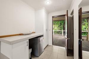 a kitchen with a counter and a door to a yard at Heritage Trail Lodge in Margaret River Town +68 photos