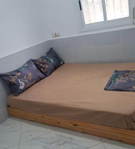 a bed in a room with two pillows on it at Aqoua private villa in Tétouan +26 photos