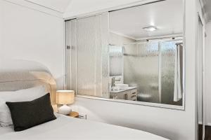 a bedroom with a bed and a large mirror at Heritage Trail Lodge in Margaret River Town +68 photos