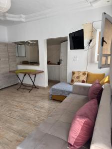 a living room with a couch and a table at Douja Apartment in Nabeul