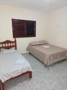 Postel nebo postele na pokoji v ubytování Casa de Praia Lucena + 15 fotografií
