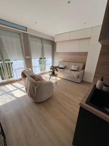 a large living room with a couch and a table at Escapade à la mer studio in Dinard
