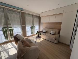a living room with a couch and a table at Escapade à la mer studio in Dinard