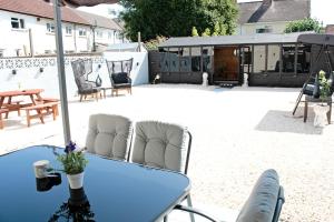 a blue table with two chairs on a patio at Cardiff - Sleep 7- Hot tub, Sauna in Cardiff
