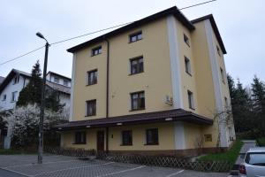 a large yellow building with a lot of windows at Willa Urocza in Lublin