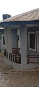 a small house with a blue roof at GA guest House in Ibadan