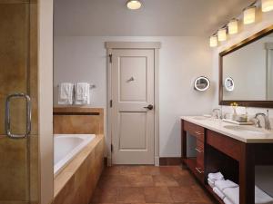 a bathroom with a tub and a sink and a bath tub at Sheraton Steamboat Resort Villas Hotel Apartment with Resort Access in Steamboat Springs