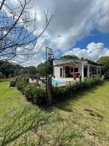 a small house with a pool in a field at Chácara de lazer Mandirituba in Rio da Várzea